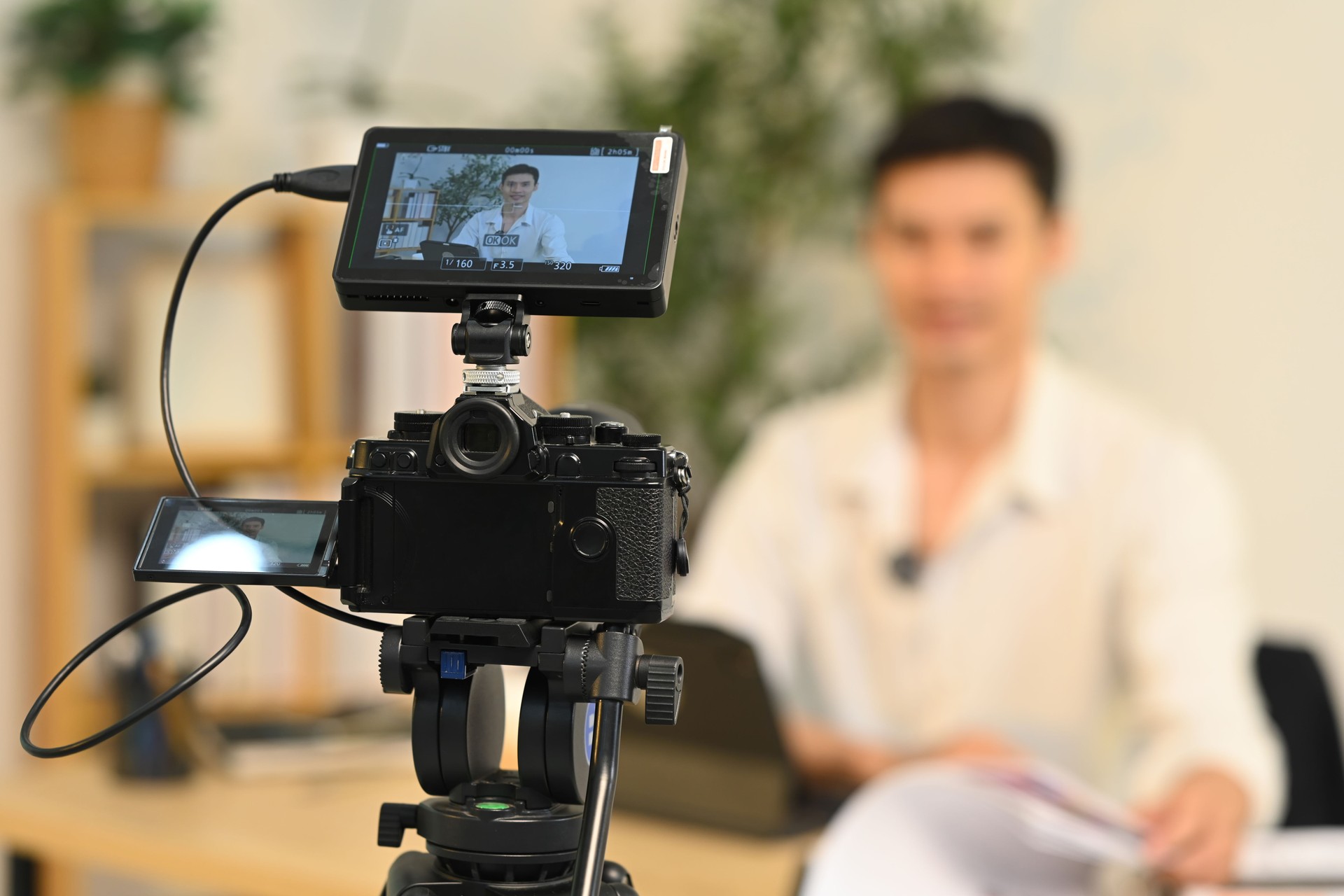 Close up of camera displaying professional businessman during on camera interview